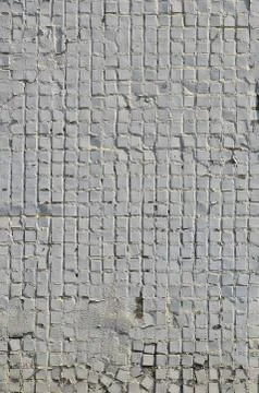 The texture of the old concrete wall, with a coating of shallow tiles of squa Stock Photos