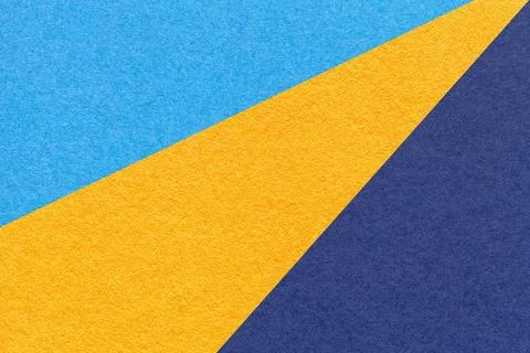 Texture of old craft navy blue and yellow color paper background, macro. Stock Photos