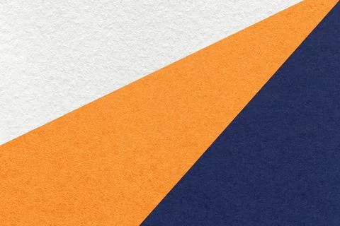 Texture of old craft white, orange and navy blue color paper background, macr Stock Photos