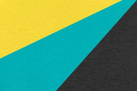 Texture of old craft yellow, turquoise and black color paper background, macr Stock Photos