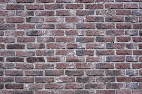 The texture of the old dark red brick wall. Stock Photos
