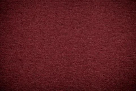 Texture of old dark red paper background, closeup. Structure of dense maroon  Stock Photos