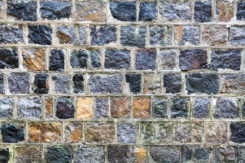 Texture of old granite wall, with cement mortar between bricks Stock Photos