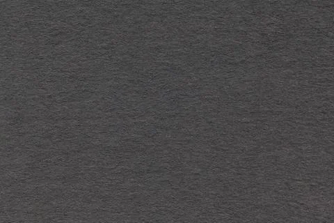 Texture of old gray paper closeup. Structure of a dense cardboard. The black  Stock Photos