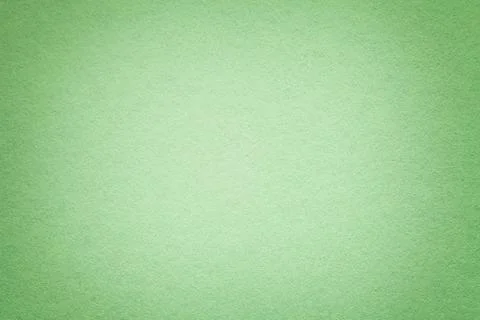 Texture of old green paper background, closeup. Structure of dense light oliv Stock Photos