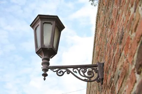 Texture of old hanging lantern on brick wall 写真素材
