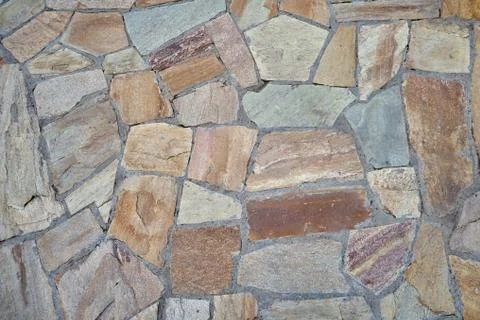 Texture of old irregular shaped tiles made of stones of different sizes 스톡 사진