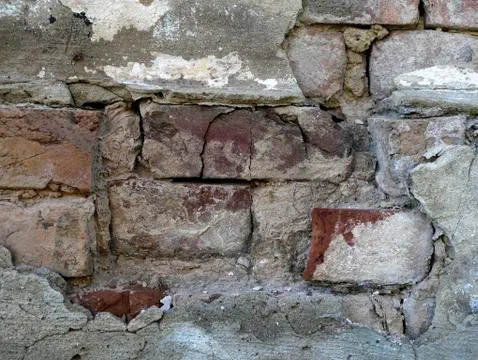 The texture of the old light wall with a sprinkled plaster Stock Photos