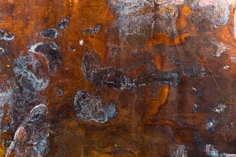 Texture of old oxidated sheet of brass with colorful spots and some minor scr 库存照片