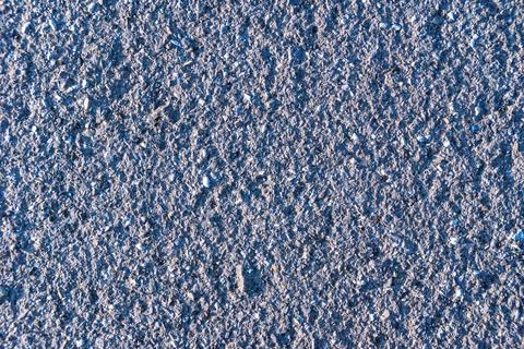 Texture of an old pavement with asphalt paved worn by millions of feet Stock Photos