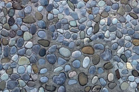 Texture of old pebblestone road. Horizontally seamless background Stock Photos