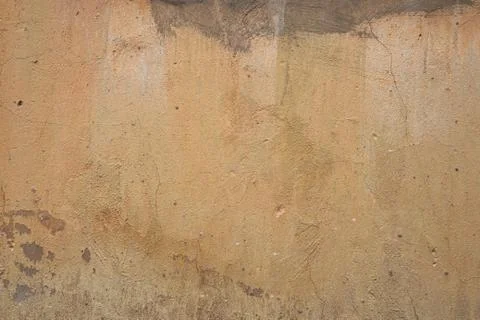 The texture of an old peeling concrete wall painted orange Stock Photos