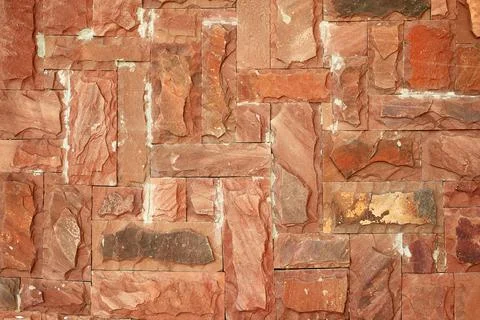 Texture of an old red brick stone wall with scuffs and scratches Foto stock