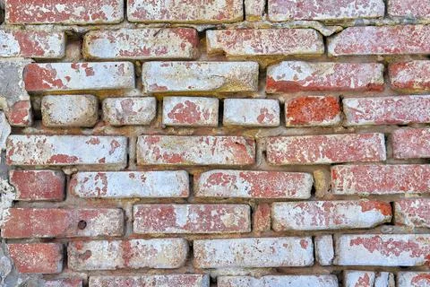 The texture of an old red brick wall. Close-up, pattern. Stock Photos