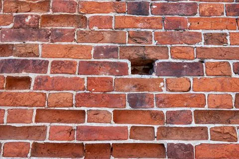 The texture of an old red brick wall. Close-up, pattern. Stock Photos