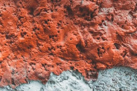 Texture of old red wall. Background of Wall fragment with broken stucco and b Stock Photos