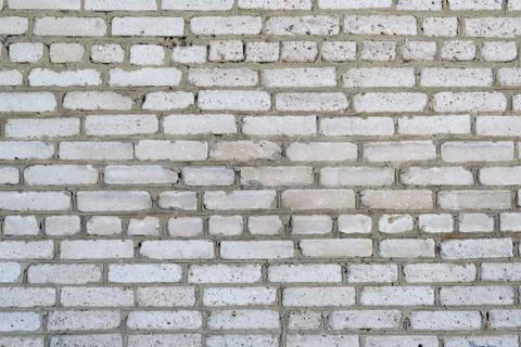 The texture of the old relief wall of white brick Stock Photos