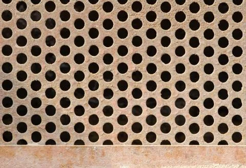 Texture of old rusty dirty grate with circle holes. Stock Photos