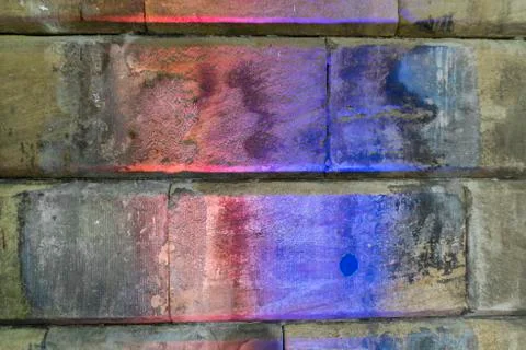 Texture of old stone blocks with colour light shining at them Stock Photos