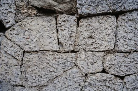 The texture of old stone blocks. Masonry walls of an old building. Stock Photos