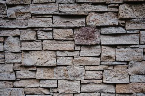 The texture of old stone or clay bricks. Masonry walls of an old building. Stock Photos