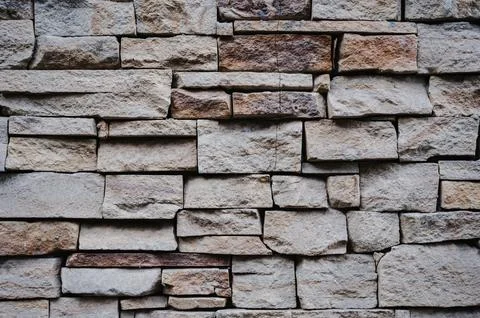The texture of old stone or clay bricks. Masonry walls of an old building. Stock Photos
