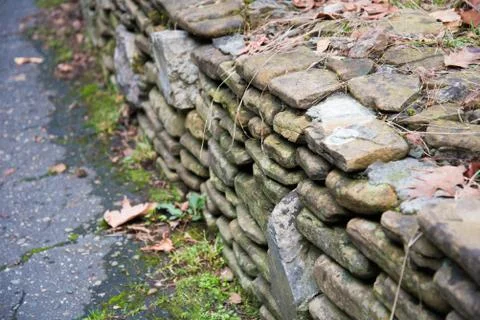 Texture of an old stone wall covered with green moss. Stones and moss. Greeting Stock Photos