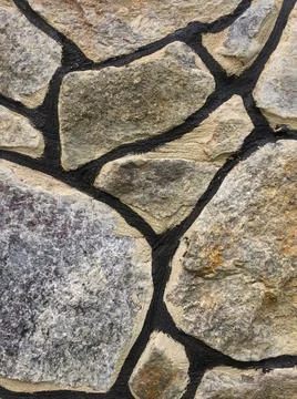 Texture of old stone wall of large boulders. Stock Photos