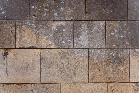 Texture of old stone wall with white paint stains and mold close-up Stock Photos