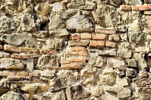 The texture of old stones and bricks together with cement. Stock Photos