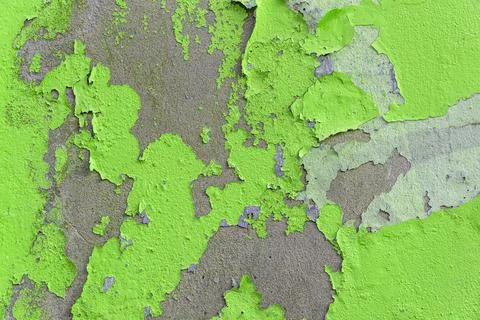 Texture of an old wall with peeling bright green paint Stock Photos
