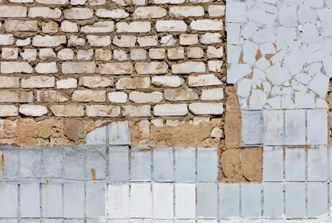 The texture of the old wall from peeling plaster and tiles, white bricks and  Stock Photos