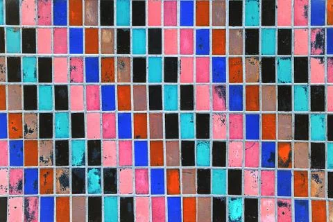 Texture of old wall tiles with peeling bright paint. Stock Photos