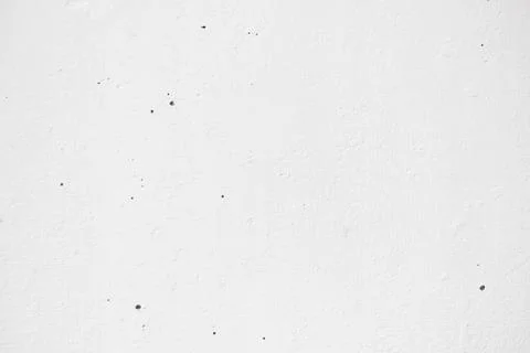The texture of an old white wall painted with paint, on a bright spring sunny Stock Photos