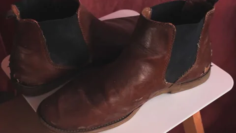 Texture of old worn ripped brown pair of leather shoes. Torn footware close up Video stock 205050732