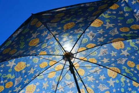 Texture of a open beach umbrella with translucent rays Stock Photos
