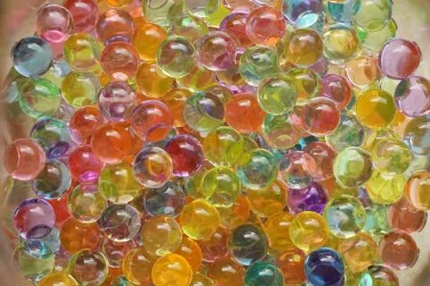 Texture or background of many-colored hydrogel balls, soil. Close up macro. W Stock Photos