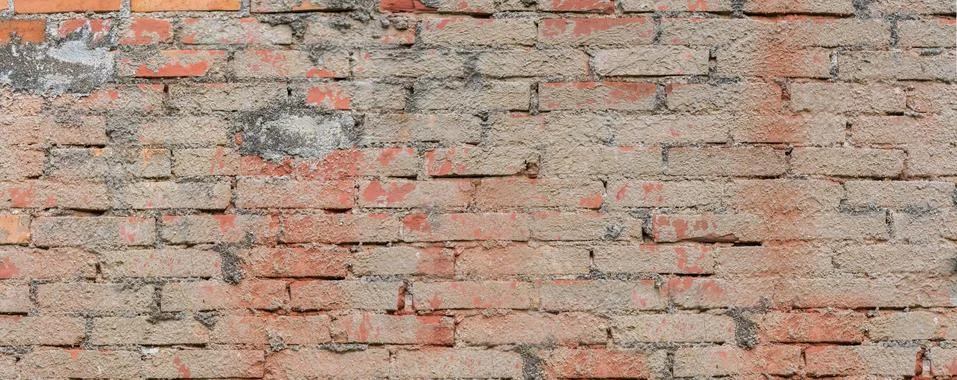 Texture of orange bricks covered with old cement grunge splatter Stock Photos