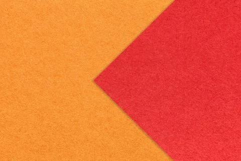 Texture of orange paper background, half two colors with red arrow, macro. 写真素材