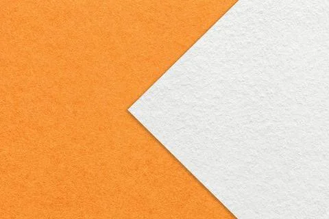 Texture of orange paper background, half two colors with white arrow, macro. Stock Photos