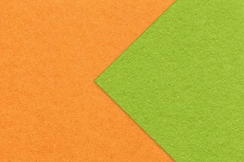 Texture of orange paper background, half two colors with green arrow, macro. Stock Photos