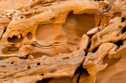 Texture of orange stone rock in a colored canyon close up Stock Photos