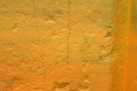 Texture of a painted wall. cement plate yellow color background. wall with bu Stock Photos