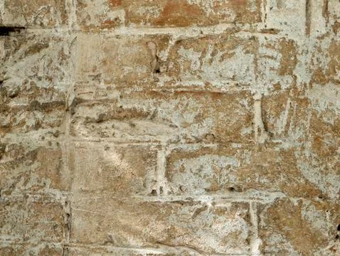 The texture of a part of a light old brick wall with sprinkled plaster Stock Photos