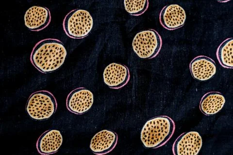 Texture with passion fruit painted in dark blue fabric Stock Photos