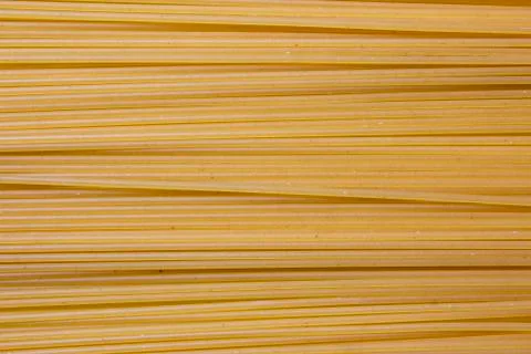 Texture of pasta macaroni from a solid wheat variety light sepia. Stock Photos