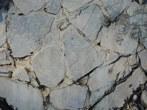 Texture of a path made of light gray chipped slabs Stock Photos