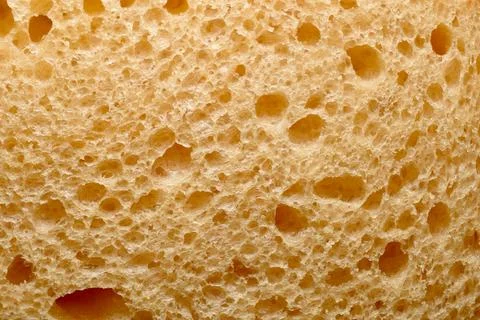 Texture pattern created by the surface of a piece of bread. Foto stock