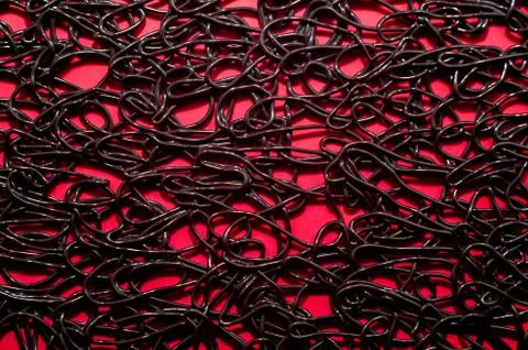 Texture pattern of dark brown rubber on a red background Stock Photos
