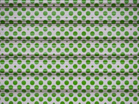 Texture pattern of green ricles on the white waved metal background Stock Photos